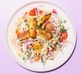 A plate of coleslaw-style salad topped with cumin-spiced halloumi