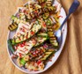 Grilled courgette & halloumi salad with caper & lemon dressing on an oval plate