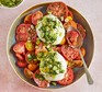 Tomato, burrata & broad bean salad served in a large bowl